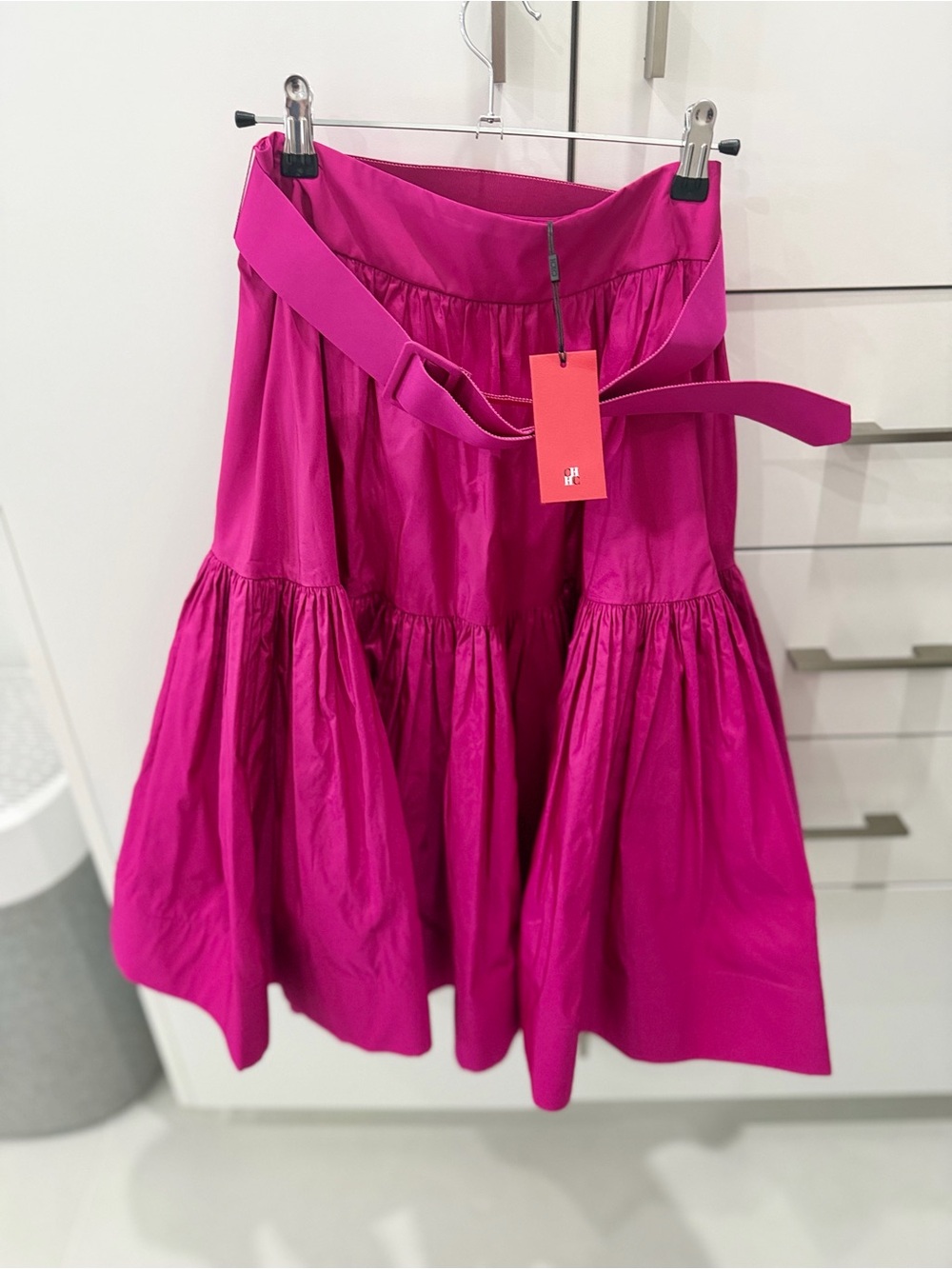 fuchsia pink Carolina Herrera belted midi skirt.